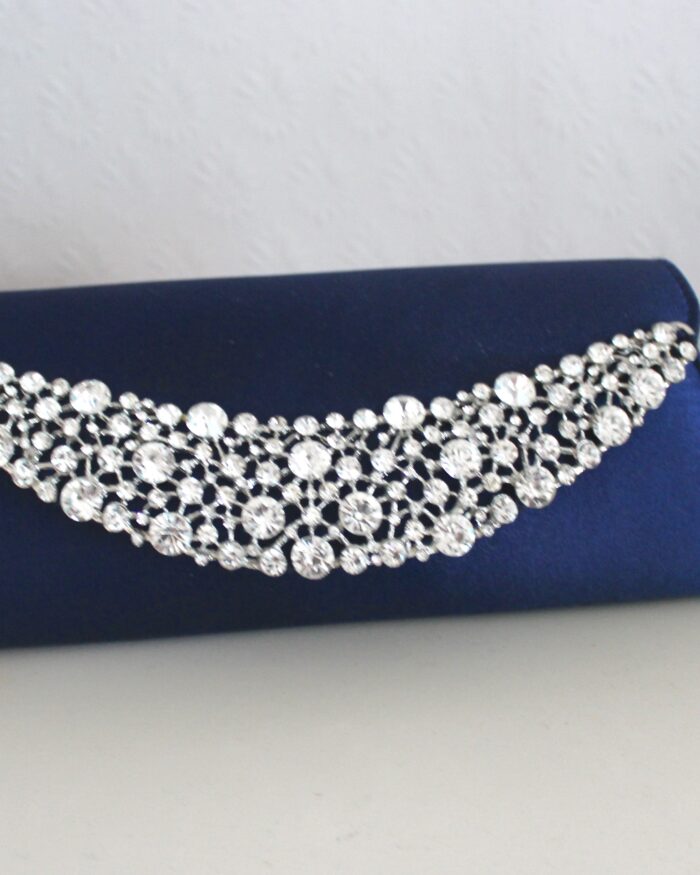 A photo of a dark blue clutch with silver embelishment on it