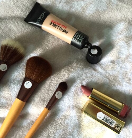 A photo of foundation, lipstick and makeup brushes with penfriend labels on them
