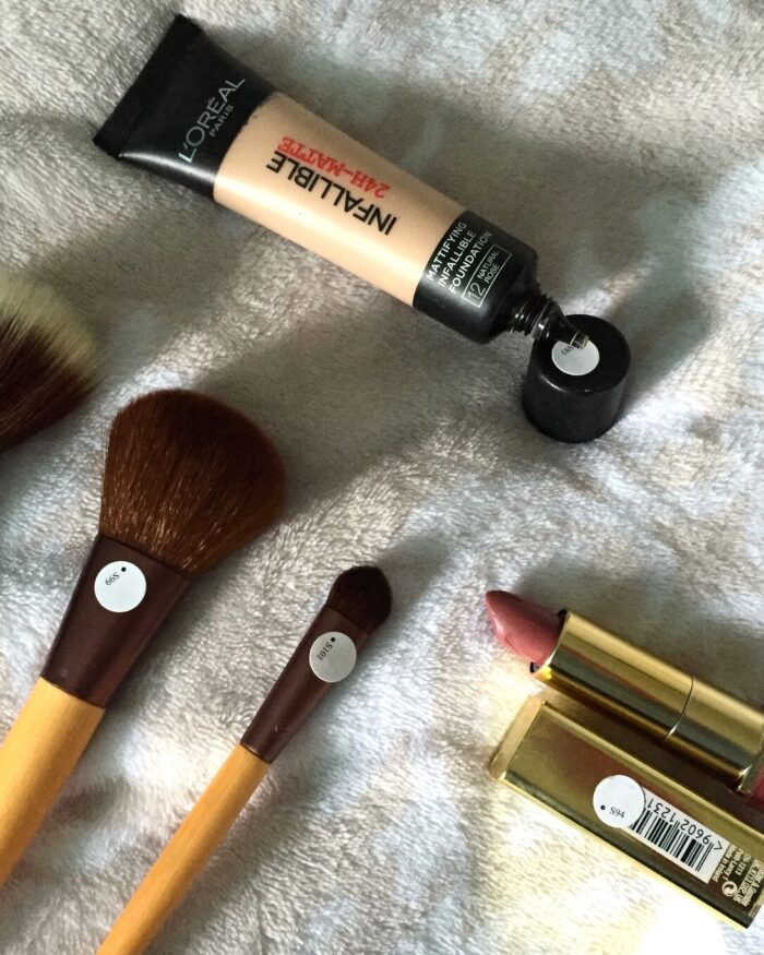 A photo of foundation, lipstick and makeup brushes with penfriend labels on them