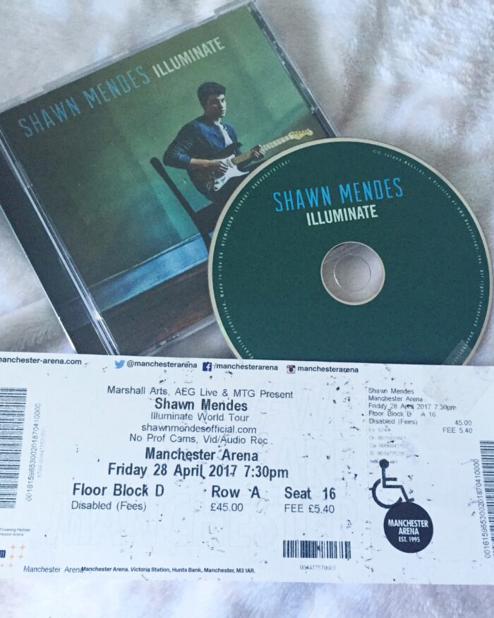 A photo of the Shawn Mendes illuminate album and my illuminate world tour ticket