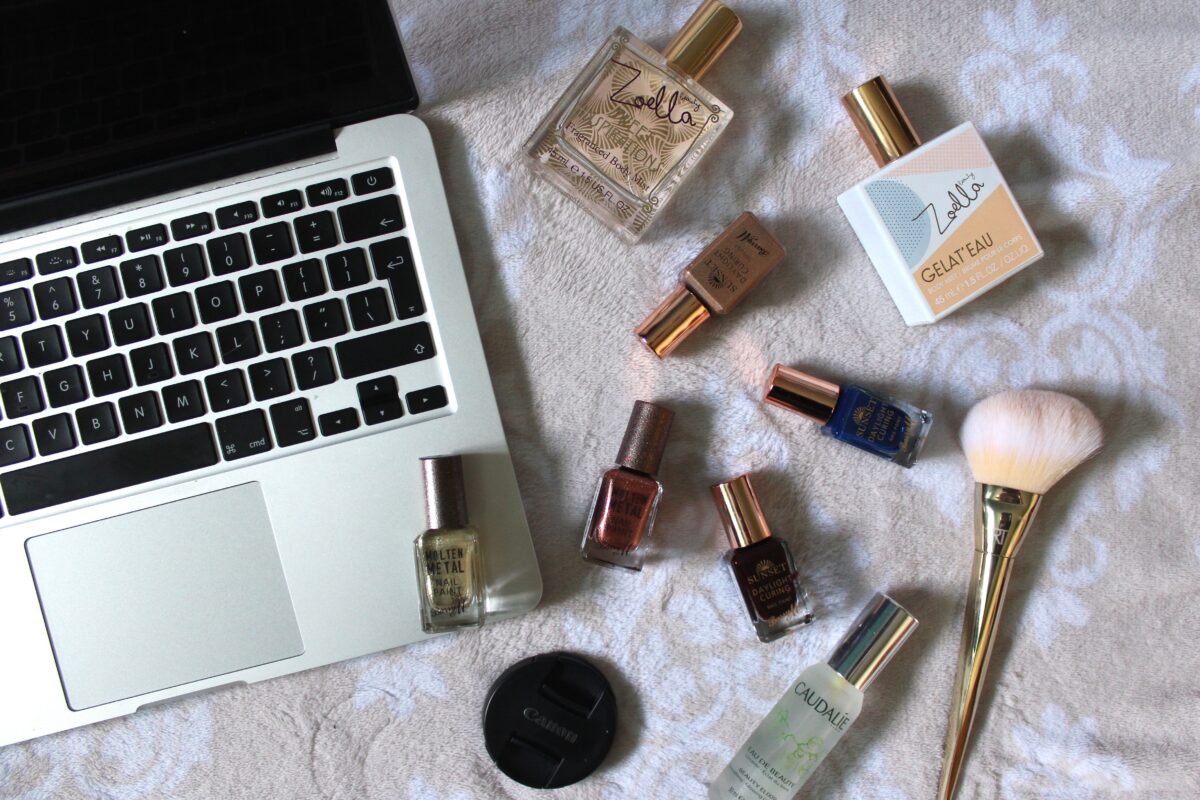 Photo of my macbook with miscellaneous beauty products next to it