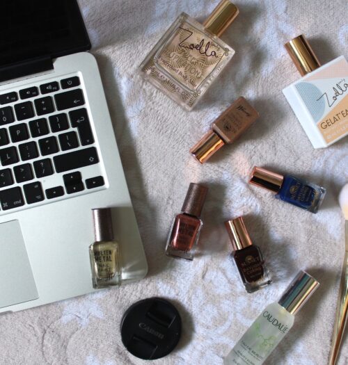 Photo of my macbook with miscellaneous beauty products next to it