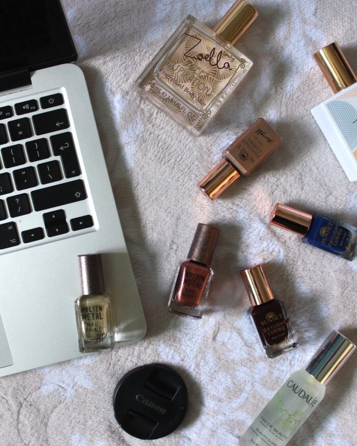 Photo of my macbook with miscellaneous beauty products next to it