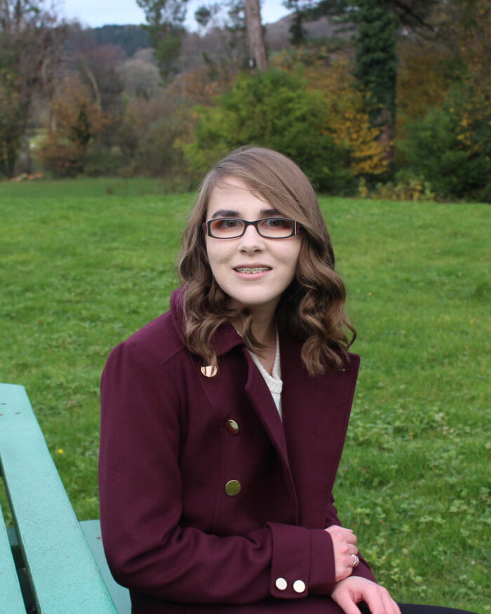 A photo of Elin sitting on a bench