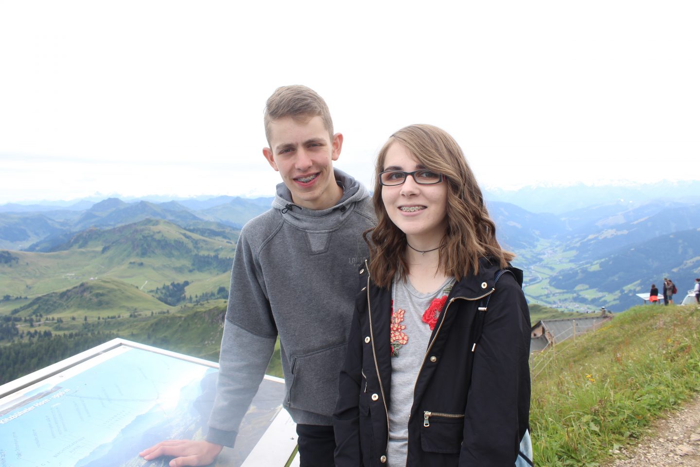 A photo of my brother and I with the mountains of Austria in the background