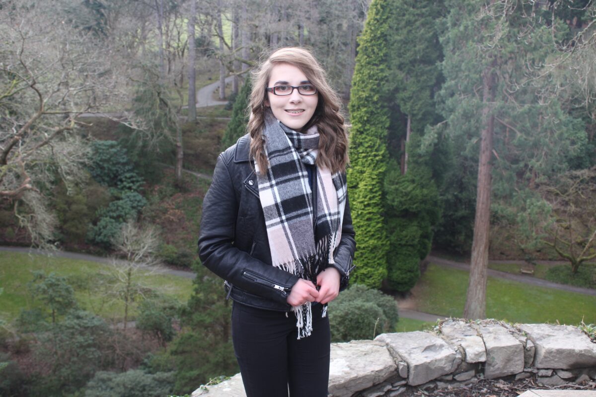 A photo of Elin with trees in the background