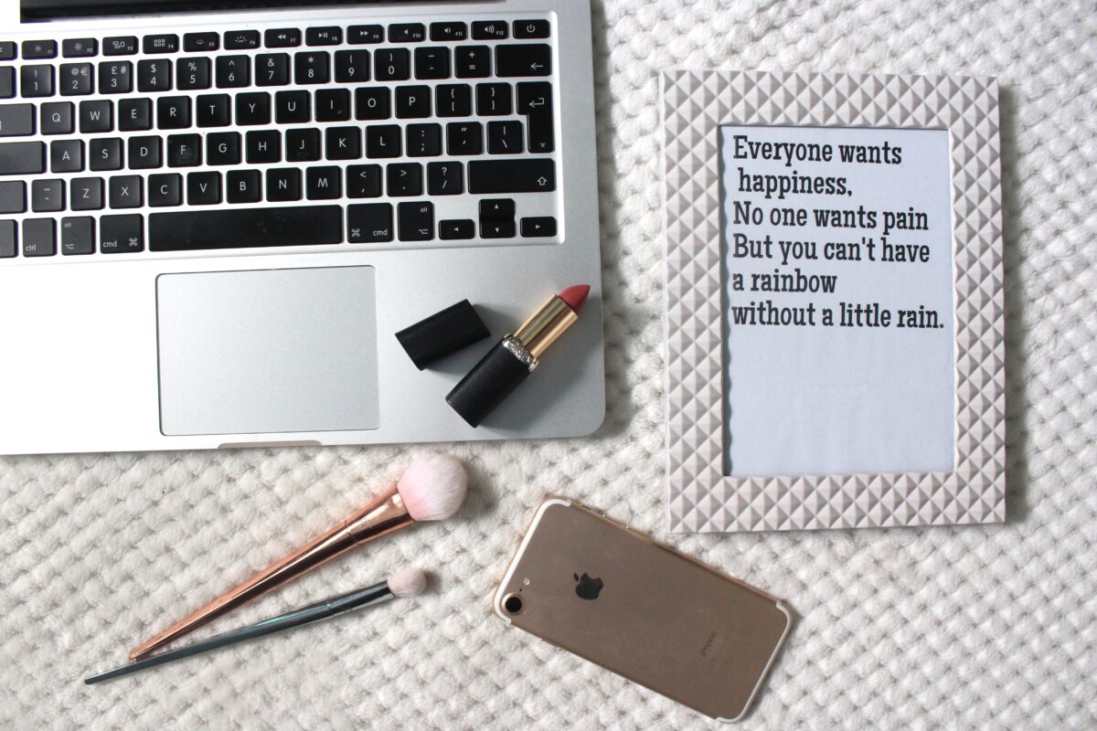 A photo of a macbook and a quote in a frame
