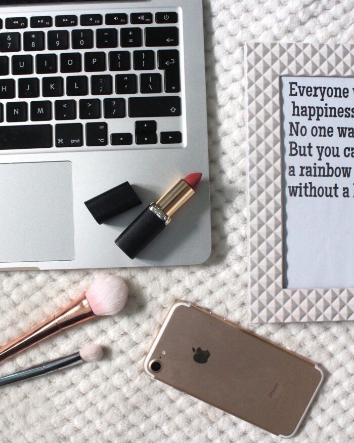 A photo of a macbook and a quote in a frame
