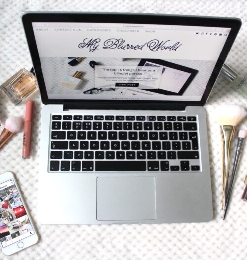A photo of my blog on a macbook, my instagram page on an iphone beside it and beauty products surrounding it