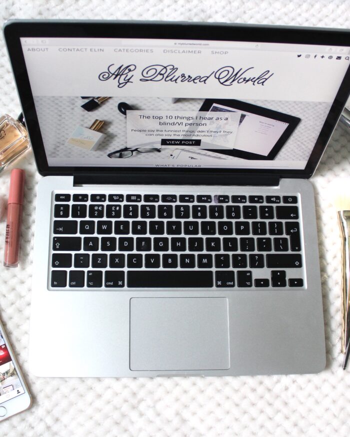 A photo of my blog on a macbook, my instagram page on an iphone beside it and beauty products surrounding it