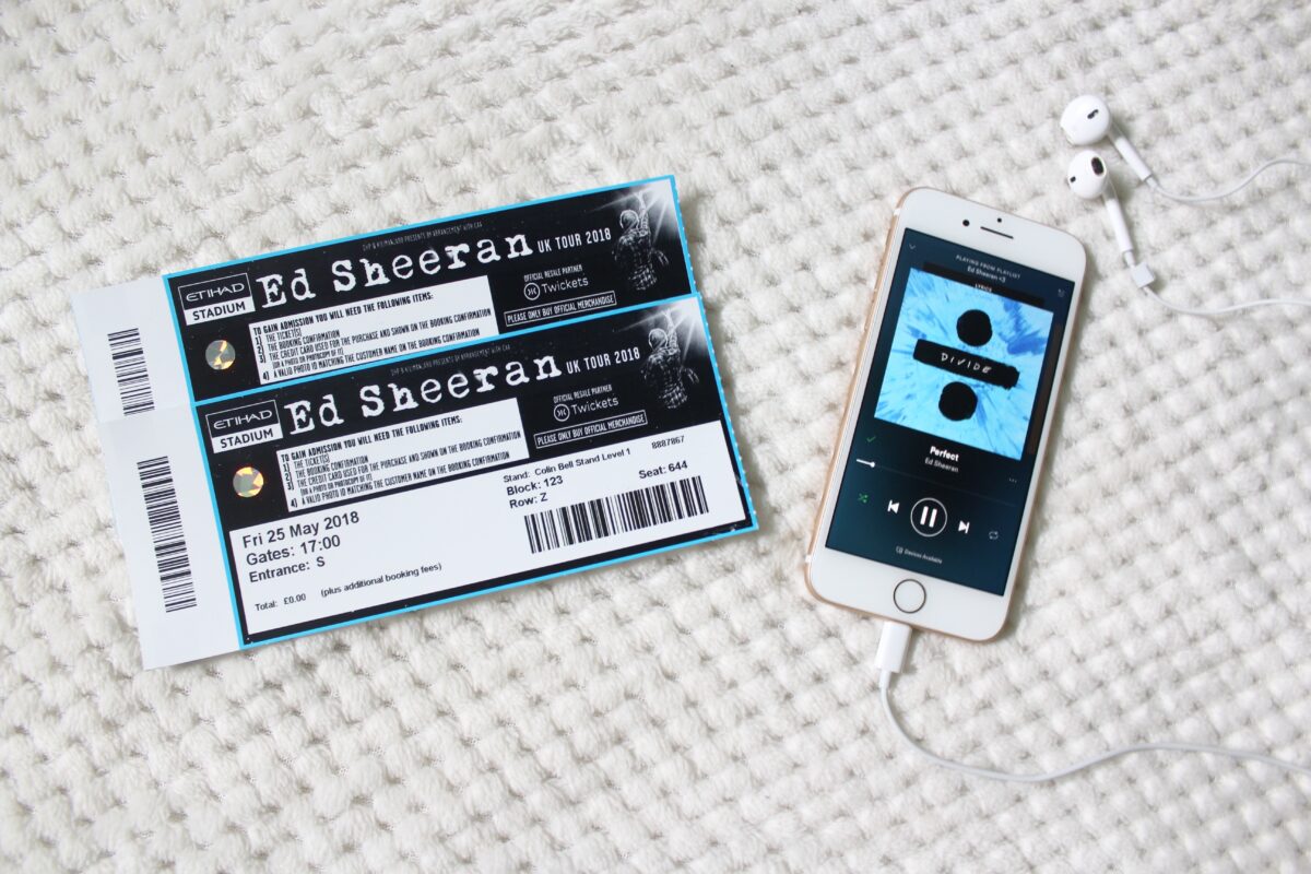 A photo of two Ed Sheeran concert tickets and my phone which has the song 'Perfect' playing on it.