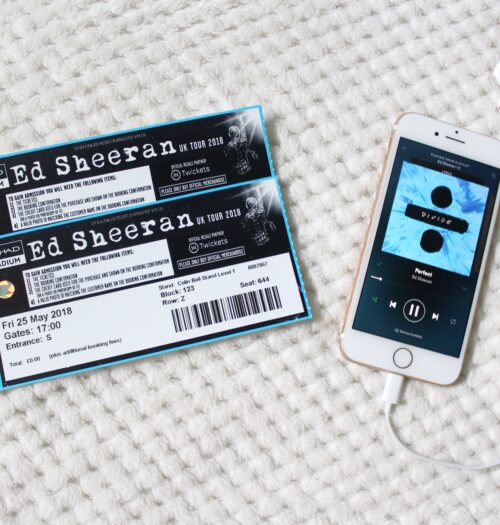 A photo of two Ed Sheeran concert tickets and my phone which has the song 'Perfect' playing on it.