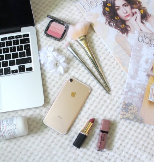 A photo of a macbook, iphone, beauty products and Blogosphere magazine
