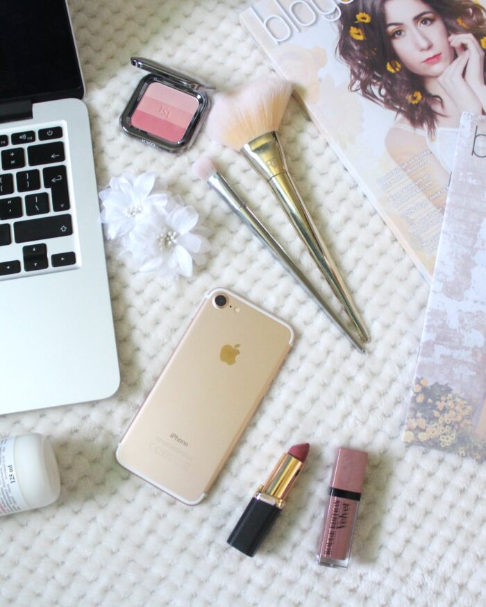 A photo of a macbook, iphone, beauty products and Blogosphere magazine