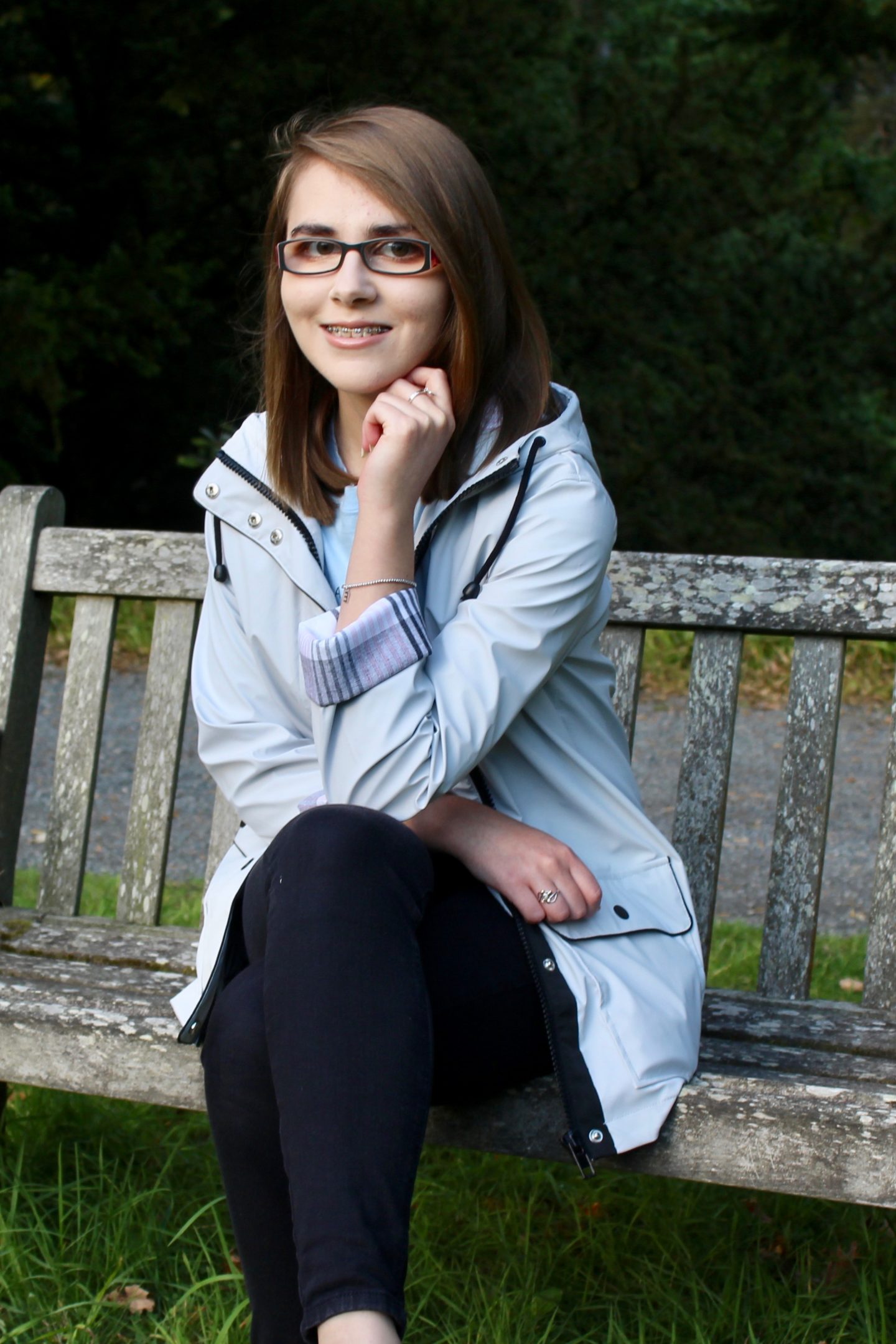 A photo of Elin sitting on a bench