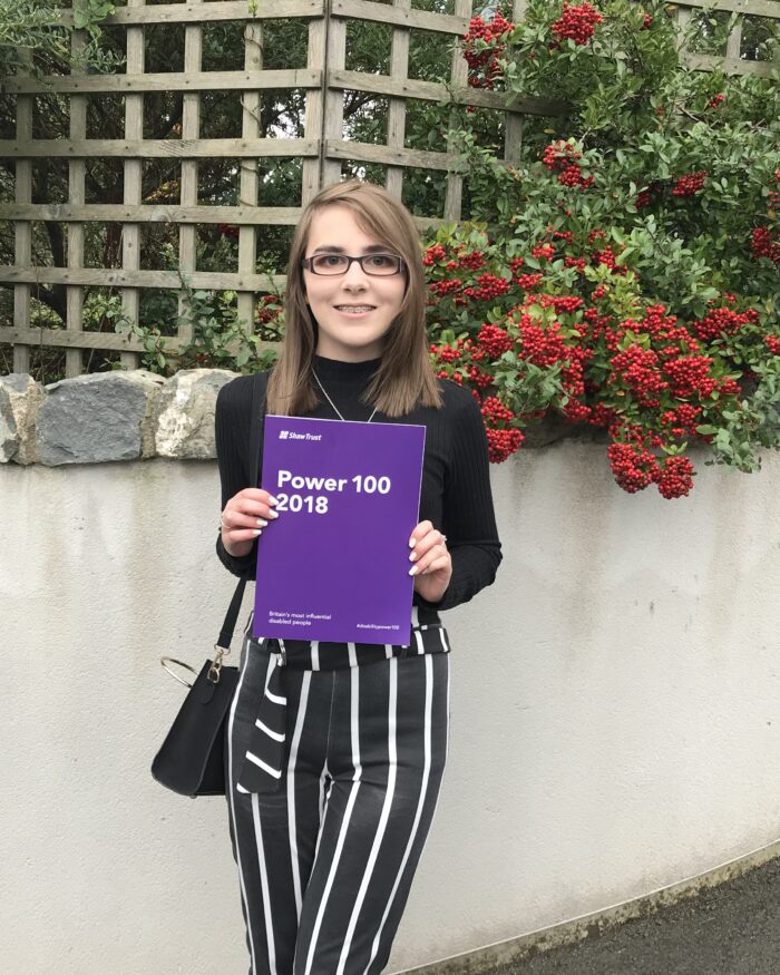 A photo of Elin holding the Shaw Trust disability power list 2018.