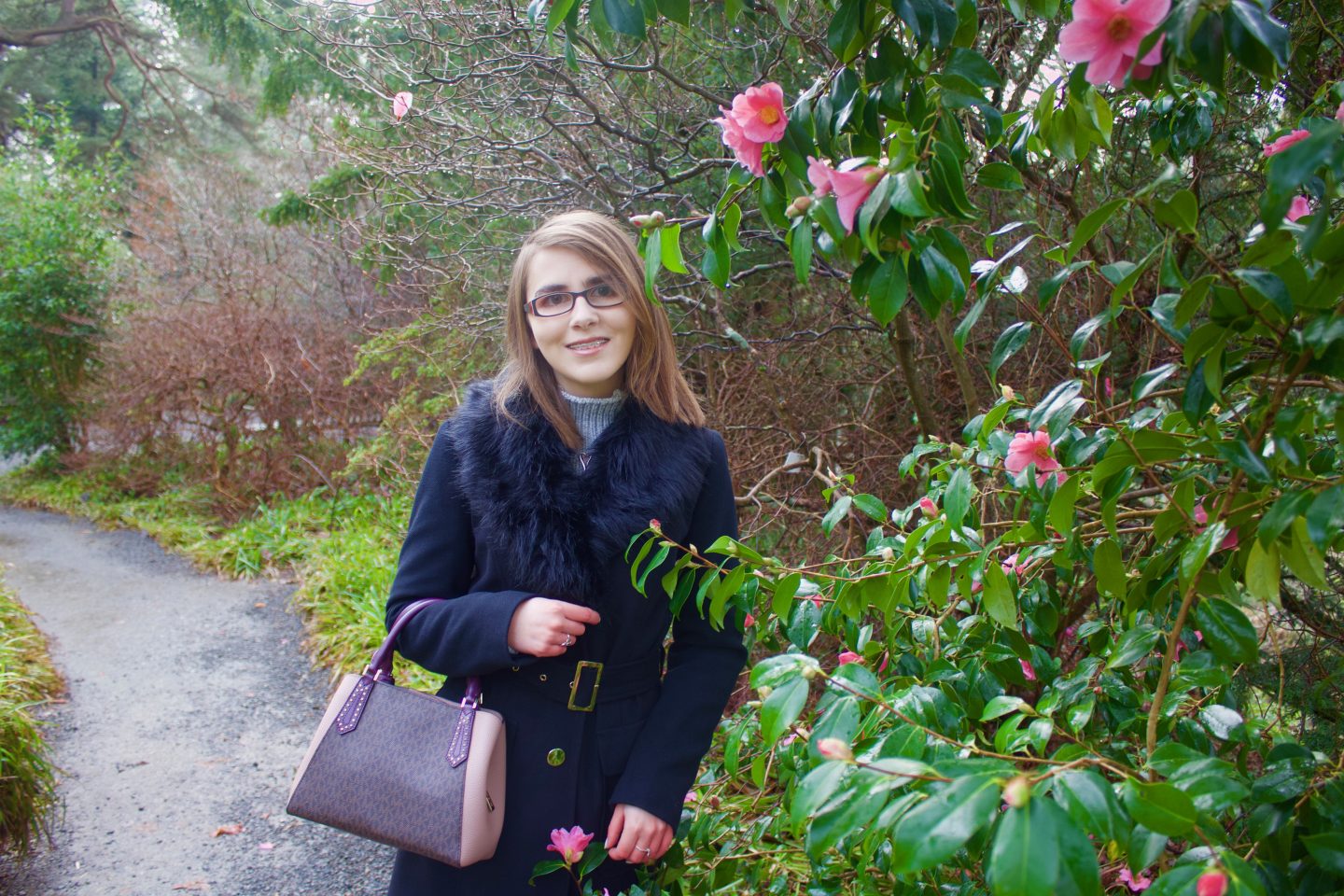 A photo of Elin amongst leaves and trees