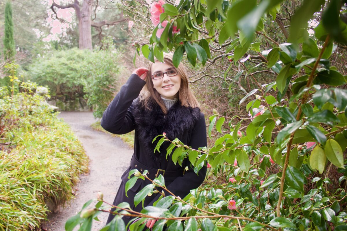 A photo of Elin amongst leaves and trees