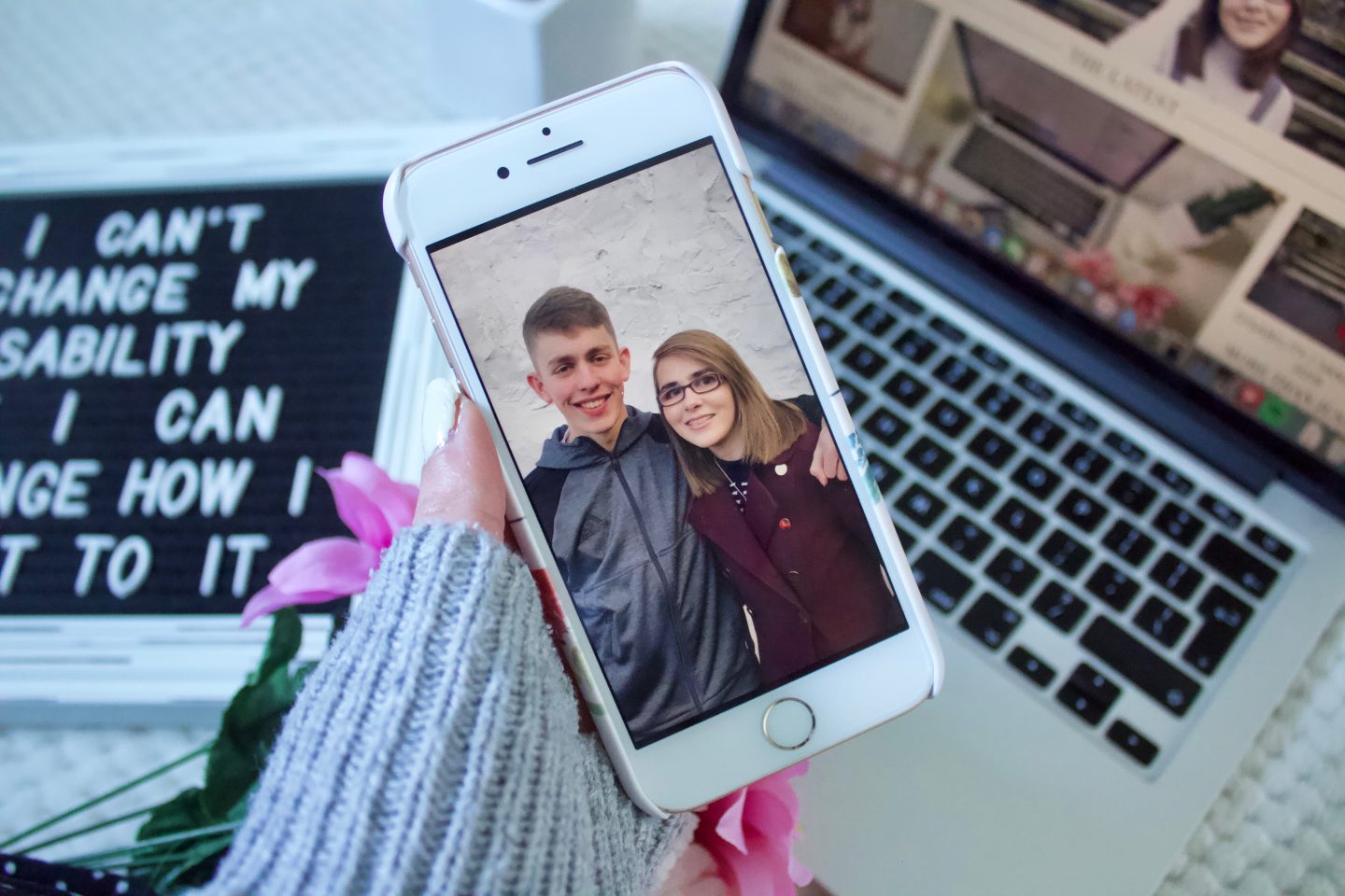 A photo of my brother and I on my phone, the objects behind my phone are blurred