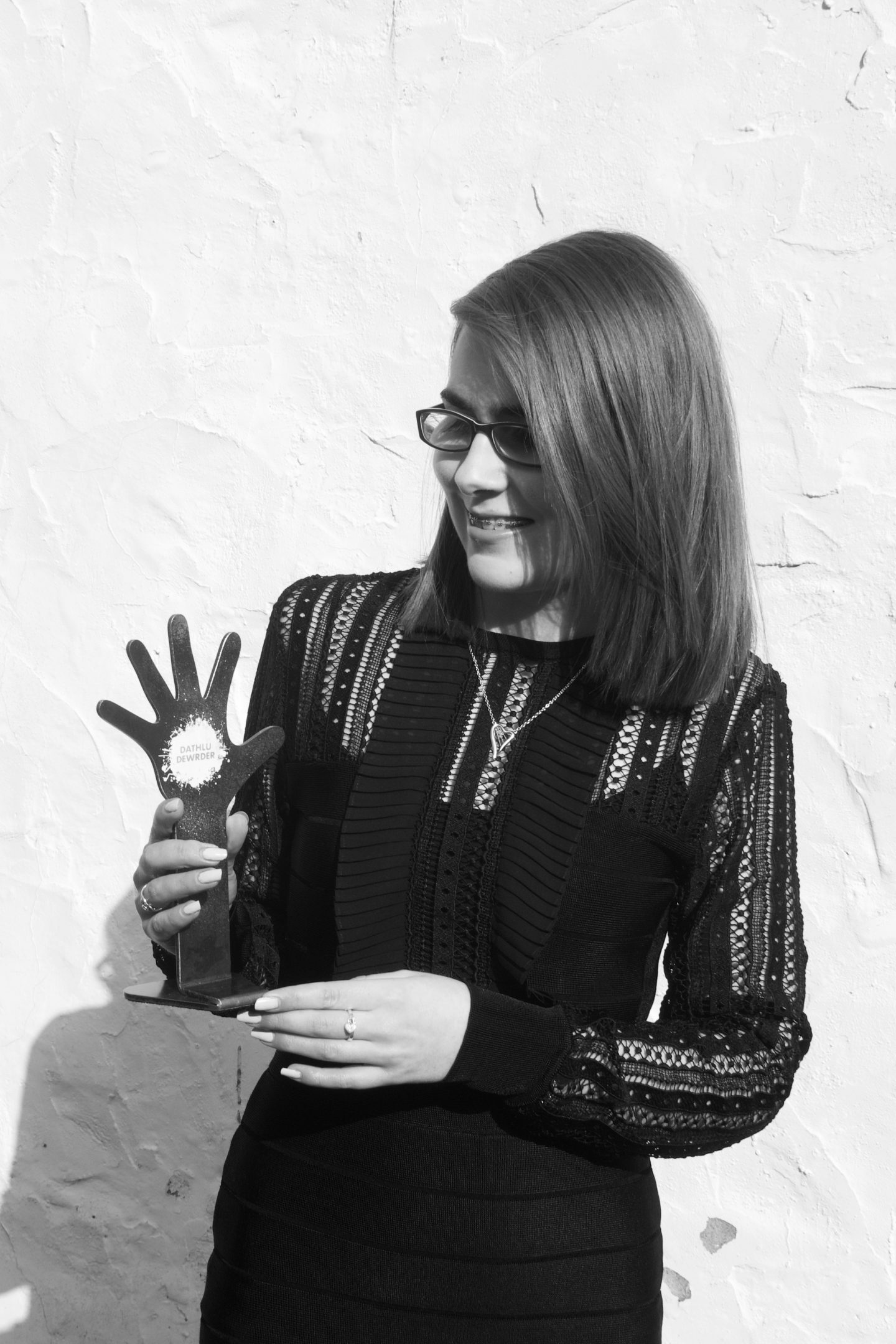 A photo of Elin looking at her award and smiling