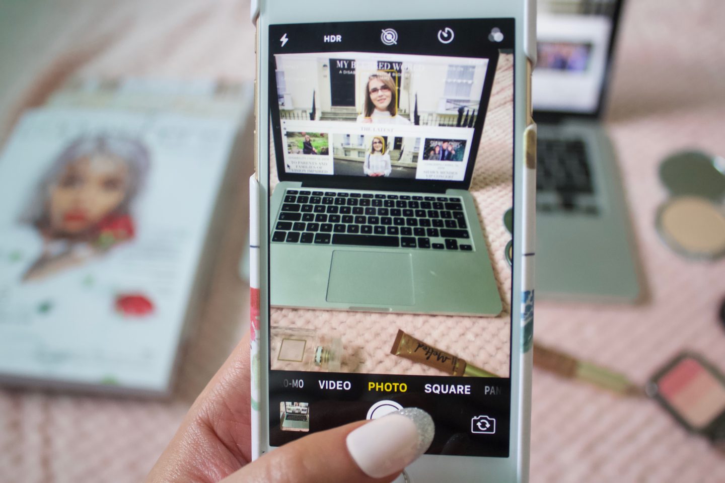 A photo of my phone's camera which is taking a photo of my blog's screen on a laptop