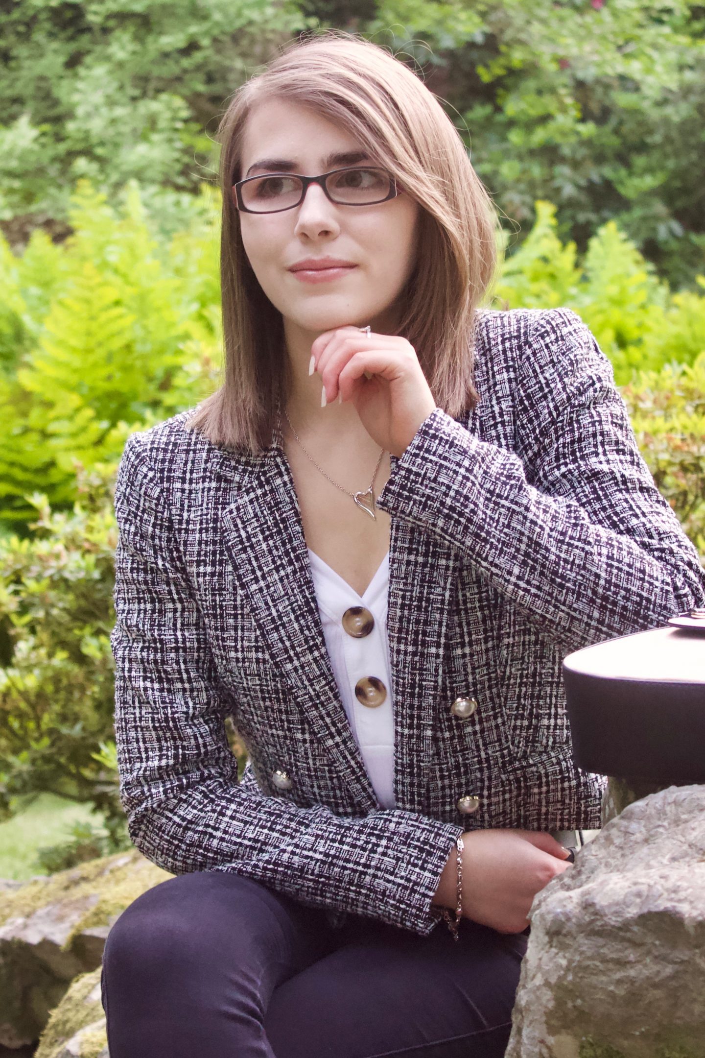 Disability & employment: A photo of Elin looking away from the camera with her hand resting underneath her chin