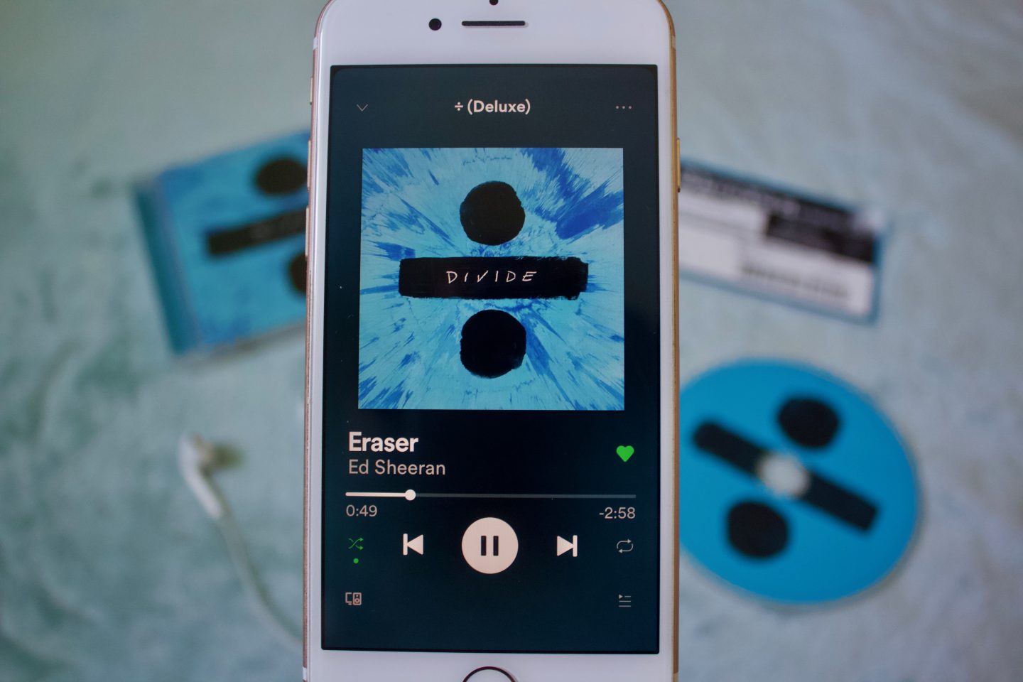 A photo of Eraser playing on my phone, the album and CD can be seen in the background which is blurred