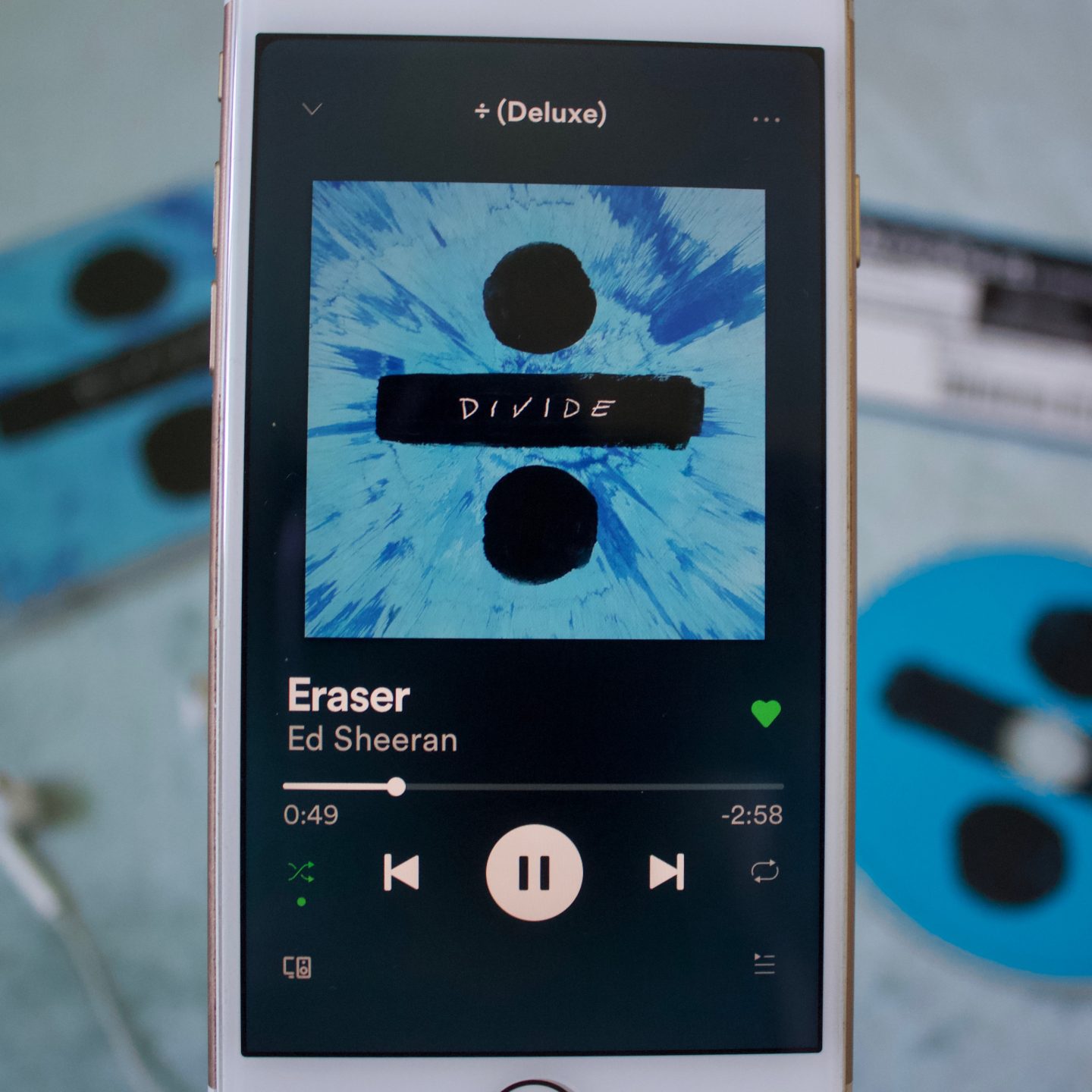 A photo of Eraser playing on my phone, the album and CD can be seen in the background which is blurred