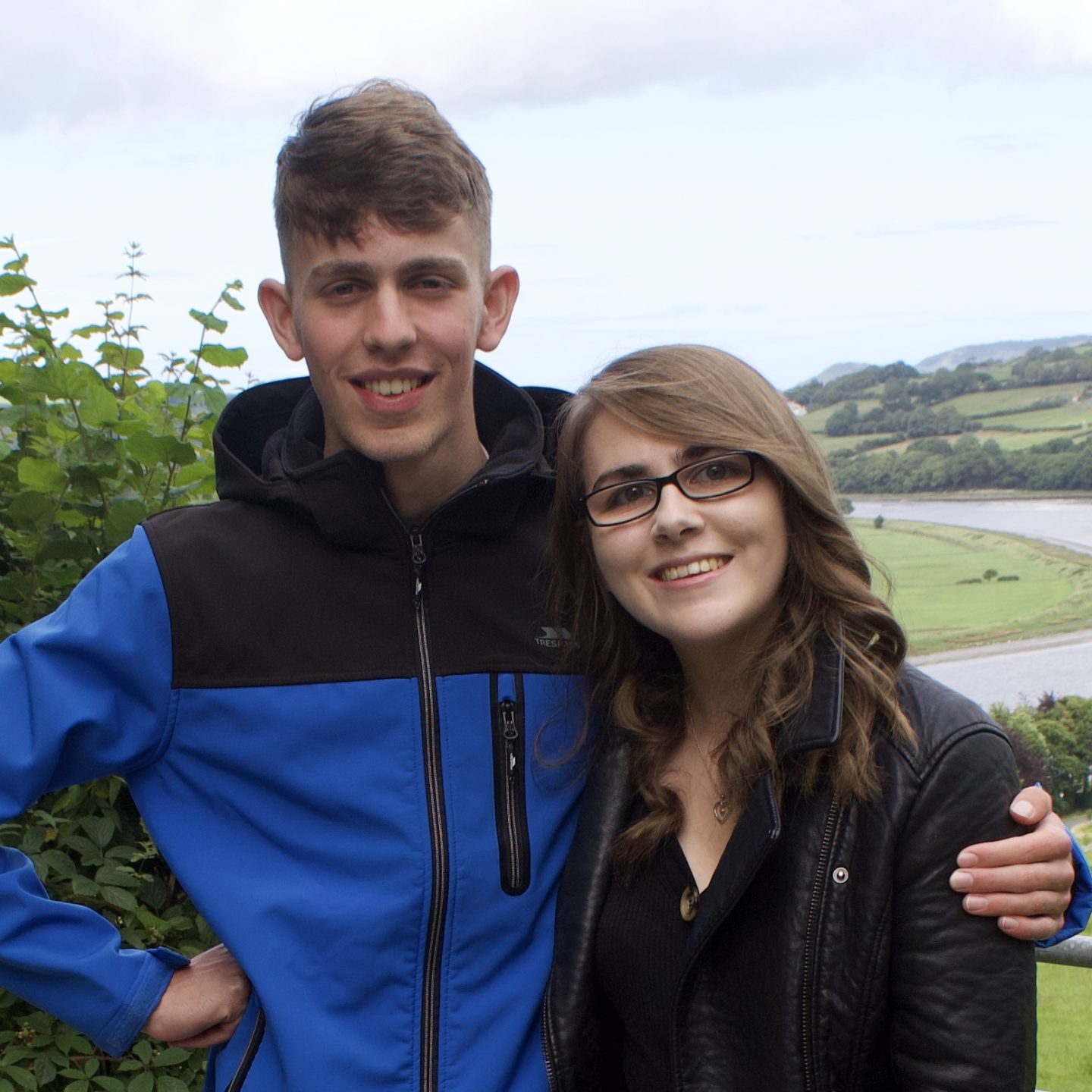 A photo of my brother and I with our arms around each other, smiling at the camera
