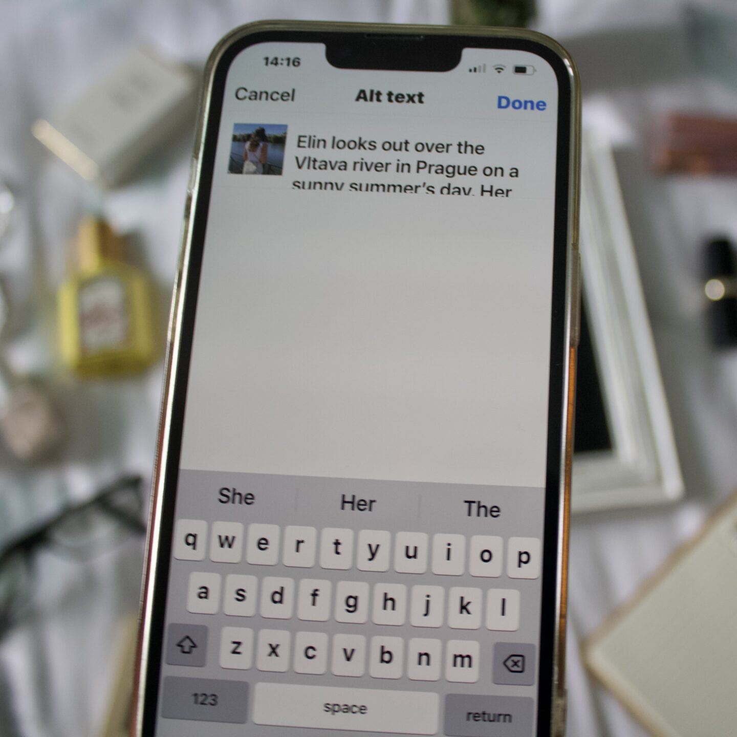 Instagram's ALT text page displayed on a phone screen. On the page is a small photo of Elin on the left with a snippet of its description beside it saying 'Elin looks out over the Vltava river in Prague on a sunny summer's day. The iPhone keyboard takes up space at the bottom of the screen.